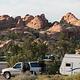 Campground road lined with campsites and boulders in the background
