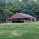 Photograph of the large covered pavilion on grassy grounds — useful to show on-site facilities and gathering space.