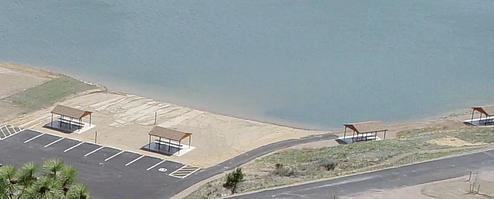 Beach/swimming area at BLM White Sandy Campground. 2 shade structures within the sandy beach area and 2 shade structures adjacent to the swimming area. These 4 shade structures are for day-use only.