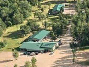 Close aerial/detail view of on-site buildings with green roofs (likely the pub/office or service buildings) and adjacent cleared areas — good facility/building image (source: Seasonal Site Information).