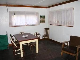Room with windows, tables, and chairs located in the middle
