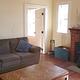 Living room, equipped with inset wood stove, couch, coffee table
