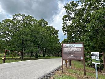 Entry gates and information board at Sunset Bay campground.