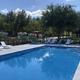 Outdoor swimming pool with lounge chairs and RVs visible beyond the fence—shows a key guest amenity and nearby RV sites from the site's gallery.