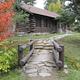 Picture of rock-lined path and log building.