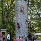 Outdoor rock-climbing wall with participants and spectators on-site—useful image of recreational amenities available at the campground (from the Amenities page).