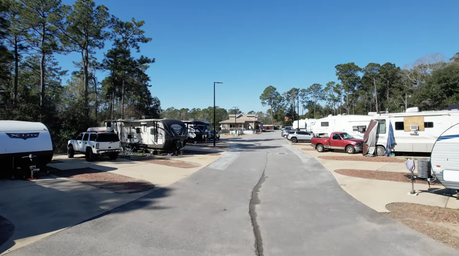 Ground-level view down the main RV lane showing pulls/parking pads and RVs on both sides — suitable for depicting campsite layout (from the gallery screenshots page).