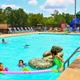Outdoor swimming pool with loungers, children and poolside facilities — demonstrates on-site recreational amenities shown on the property page.