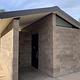 A stone pit toilet building.