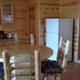 Dining area and kitchenette inside a cabin/rental — from the Rentals page, useful to illustrate interior features of campground rentals.