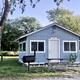 One-bedroom cabin with a picnic table and grill at Camp Riverview