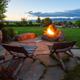 Outdoor firepit seating with landscaped grounds and distant mountain views — depicts guest amenity and scenic setting (gallery image).