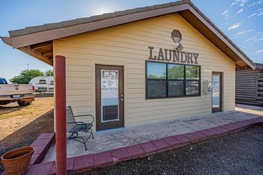 Exterior photograph of the park laundry building with surrounding RV spaces visible — shows on-site guest amenities (gallery page).
