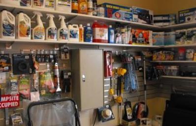 Interior retail/office shop display with RV supplies — documents on-site convenience services (store/proshop) shown on the park's Services page.