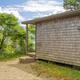 Small wood-shingled cabin labeled 'Starfish' — shows on-site cabin accommodations and building style at the property.