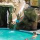 Shows on-site swimming pool with waterslide and children using it — indicates campground recreation facility; sourced from the property’s New Hampshire page of Modern America Campgrounds.