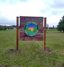 Photograph of the campground entrance sign installed on the property — useful for identification and arrival orientation. Shown on the home page.