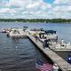 High-quality dock/piers with boats and flags — excellent overview of the marina and guest dock activity on the property (hosted on the property site).