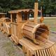 Wooden play-train structure in an open grassy area, indicating on-site family-friendly playground/recreation space — visible in the site’s photo gallery context.