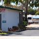 Sunrise RV Park entrance with office and RV.