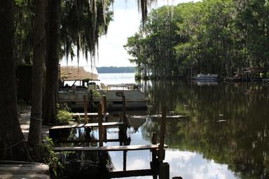 Waterfront dock and calm canal at Lake Rousseau RV Resort