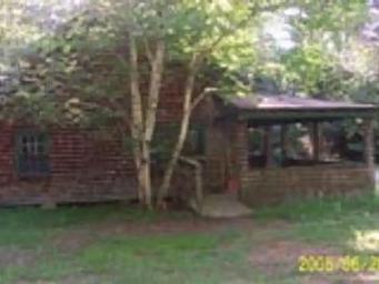 Exterior of a wooden cabin with a large porch