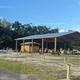Large covered pavilion with people and adjacent grounds visible — shows an on-site gathering/activity facility used by the resort (page gallery context).