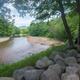 Scenic riverside overview showing the Saco River, sandy banks and river-edge trees — useful as an overall grounds/landscape photo; appears on the property site as a background/feature image for river views.