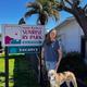 Vertical photo of the park’s main sign with a person and dog at the entrance — useful identifying shot for the property and appears in the park’s About/entrance gallery.