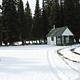 Snowy landscape with Buck Park Cabin in the background.