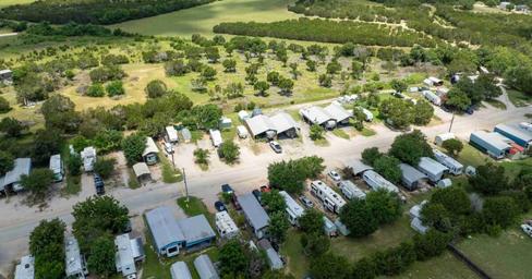 High-angle view down the main park road with RV sites on both sides, useful for showing overall scale and site arrangement (site social image / homepage).