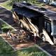 Close view of a large motorcoach on a paved pull-through site with patio — from the RV sites page, useful to show the RV accommodations and site layout for large rigs.