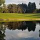 Wide scenic view of a pond and adjacent fairway/greens — useful aerial/landscape overview showing the resort’s golf course and water feature (source: homepage/gallery golf imagery).