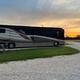 Large RV parked on a gravel pad at sunset — shows an RV site and surface type, useful for guests (appears on Rates & Policies page).