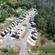 Aerial drone view showing the full RV layout, central clubhouse/pool and surrounding trees — matches the site’s overview/gallery content (file DJI_0301 on homepage).