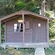 Sergief Island Cabin exterior brown wood cabin with greenery surrounding it