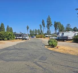 Driveway/road through the RV parking area with multiple RVs and pull-through spaces — shows site configuration and pavement condition (from the property gallery).