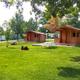 Clear daytime photo of on-site wooden cabins, picnic table, fire ring and grassy lawn — shows cabin accommodations and campground grounds. Image comes from the property website (Cabins-052.jpg) and matches the Meadow Lake Campground pages.