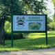 Entrance sign reading 'Riverside Campground' on site — verifies property identity and is useful for guests locating the campground (from Campground Rentals page).