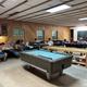 Interior of the recreation hall showing pool table, seating and activity space — represents on-site facilities and communal indoor amenities (from ‘Around the Camp’ page).