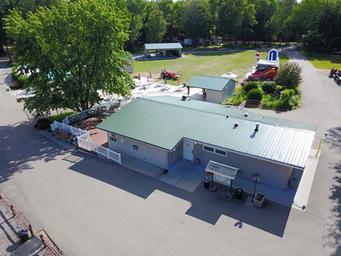 Aerial view of the main service building/amenities area adjacent to the pool — good for showing on-site facilities; sourced from the amenities page.