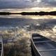 Two canoes at Nine Mile Pond during sunset.