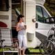 woman having coffee in front of RV