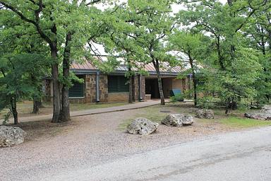 Brick building left of roadway in D Loop surrounded by trees.