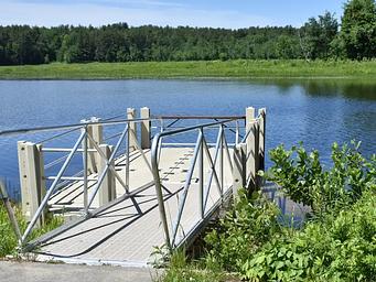 The Elm Brook Park fishing dock overlooking Hopkinton Lake on a sunny day.
