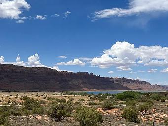 Overview of Ken's Lake Campground with red rock cliffs lining the horizon.