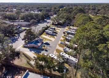 Oblique drone view showing the main office/building and rows of RV sites — good contextual overview of campground location and surroundings (from site homepage/gallery drone photos).