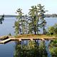 Aerial view of the Kabetogama Lake Group campsite with three large docks overlooking a large, scenic lake.
