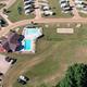 Wide aerial panorama including pool, clubhouse and rows of RV sites — good alternate crop of the property overview shown on the homepage slider.