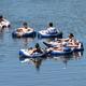 Image of tubing on the water (people on inner tubes) — illustrates lake/river recreational activity available at the resort; matches tubing/ waterfront content on the site.